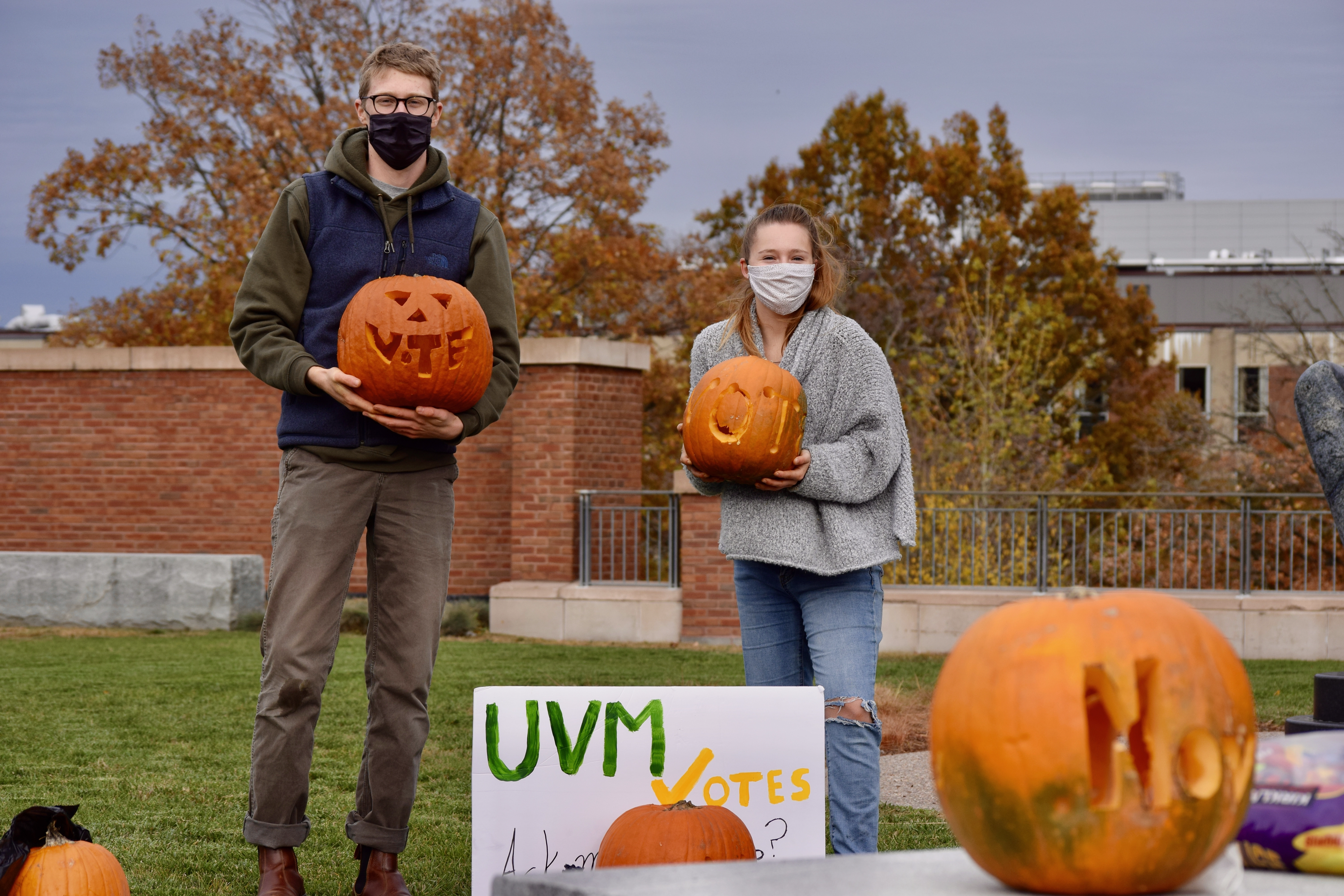 UVM Votes members carving pumpkins.